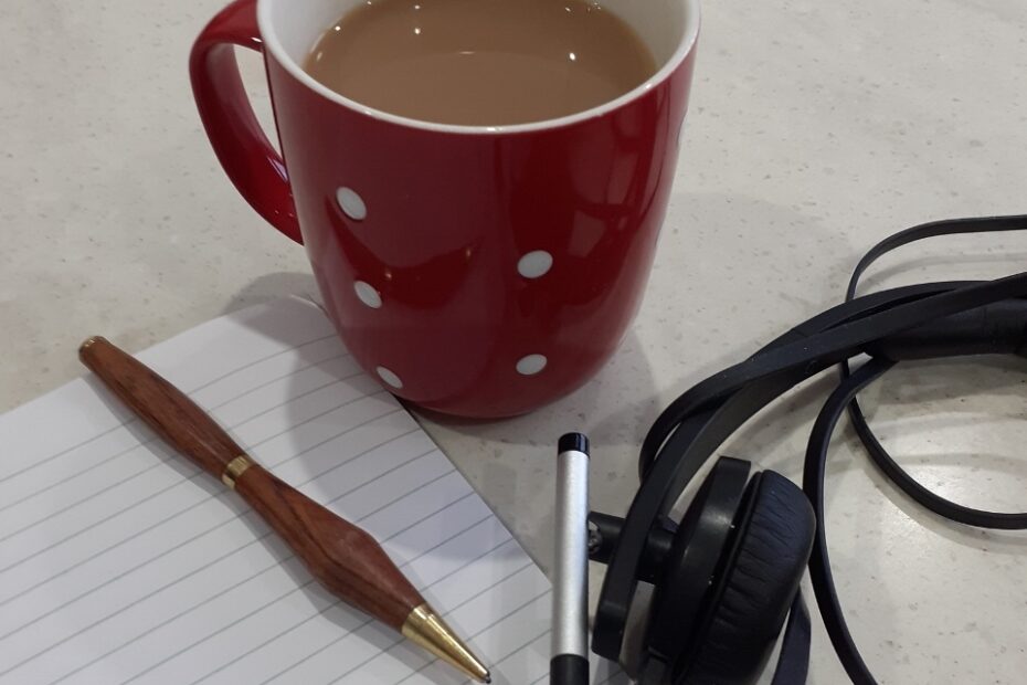 mug, notepad, pen and headphones
